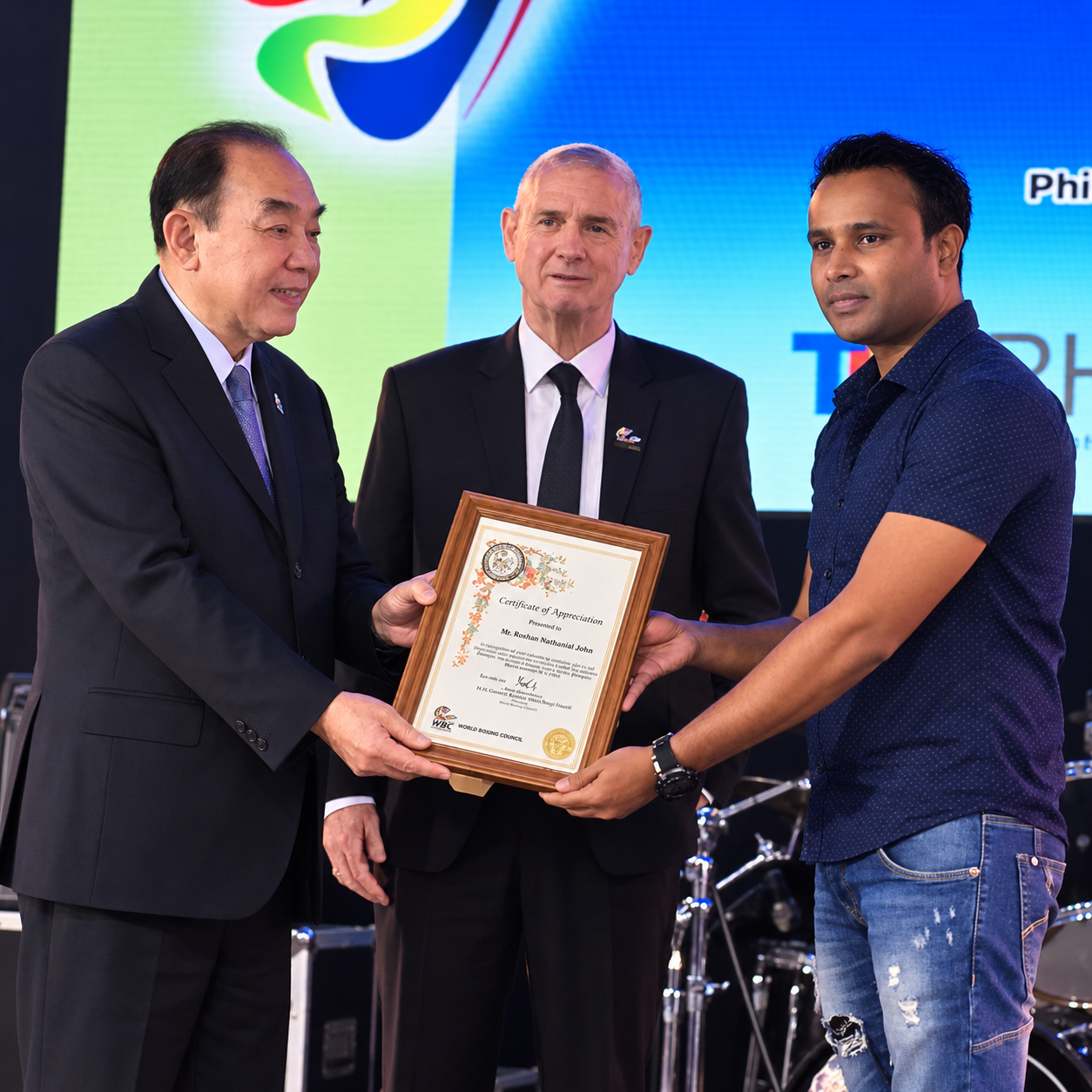 Roshan Nathanial receiving a Certificate of Appreciation at a World Boxing Council event